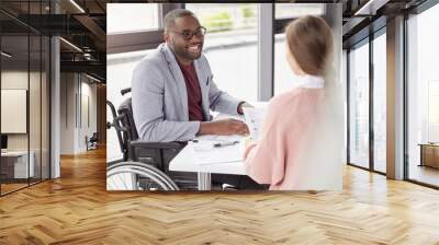 Portrait of male invalid who can`t go, sits in wheelchair, being paralysed, still work in his own comapy as director, gives commands and instruction to female secretary, happy to recieve high profit Wall mural